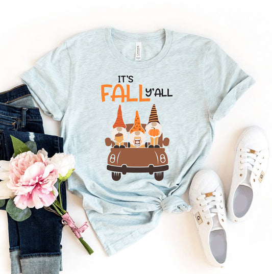 Light blue t-shirt with 'It's Fall Y'all' graphic, jeans, sneakers, and flowers on a white background